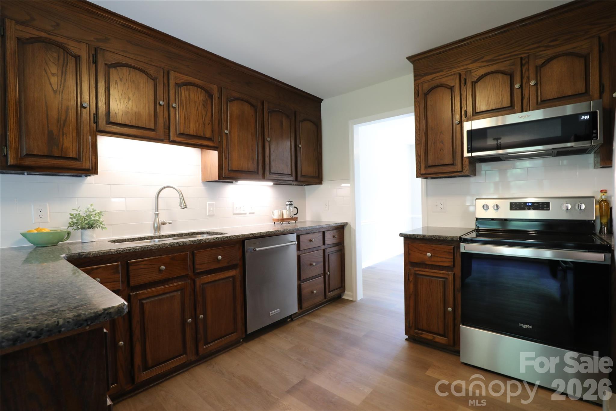 12809 Pine Bluff Road Midland, NC 28107 - Photo 9 of 41 a kitchen with stainless steel appliances granite countertop a sink stove and microwave
