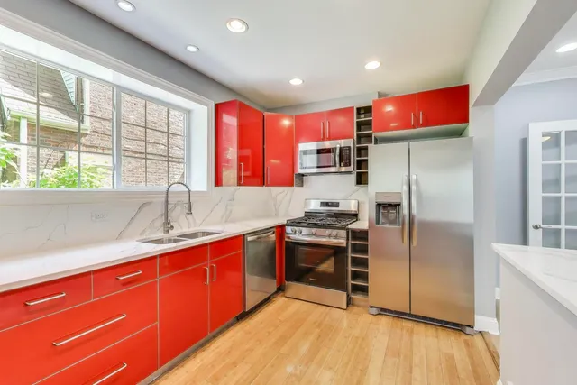 a kitchen with stainless steel appliances granite countertop a refrigerator and a sink