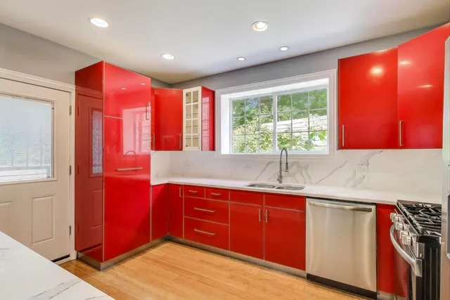 a kitchen with a sink window and cabinets