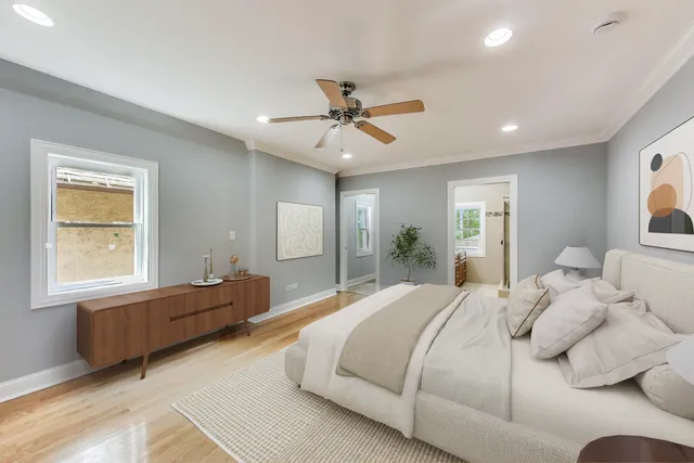 a spacious bedroom with a large bed and a chandelier