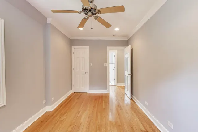 a view of room with wooden floor and ceiling fan