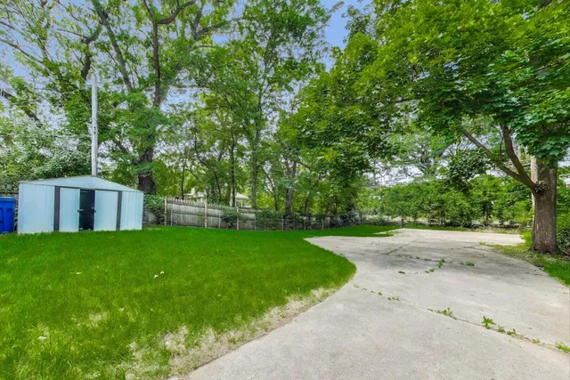 a view of a backyard with large trees