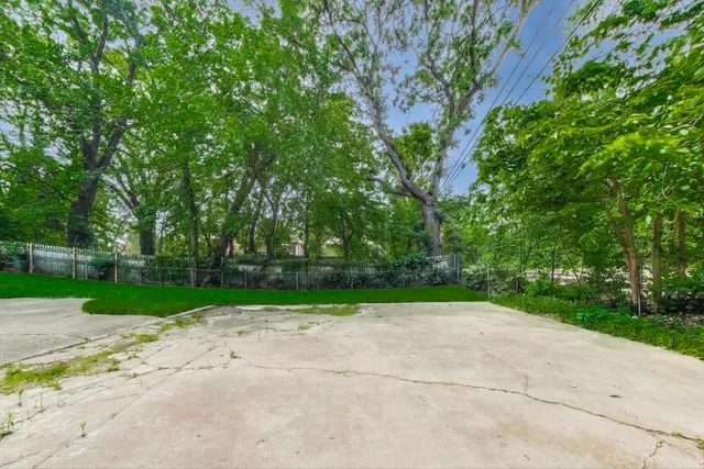 a view of a road with a big yard