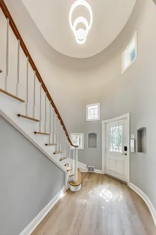 a view of entryway and hall with wooden floor