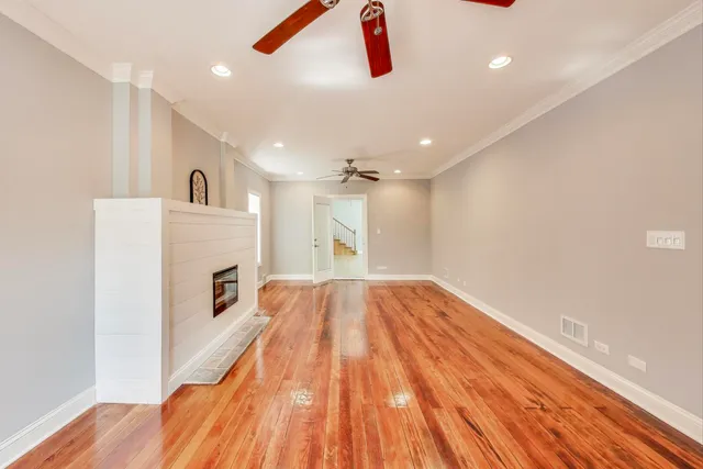 a view of empty room with wooden floor