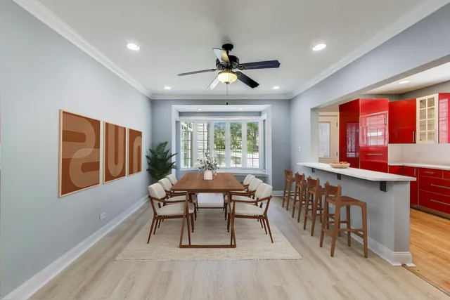 a dining room with furniture a window and wooden floor
