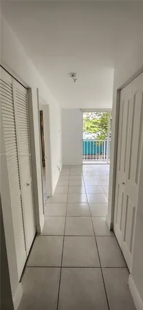 a view of hallway with furniture and a window