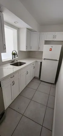a utility room with cabinets washer and dryer