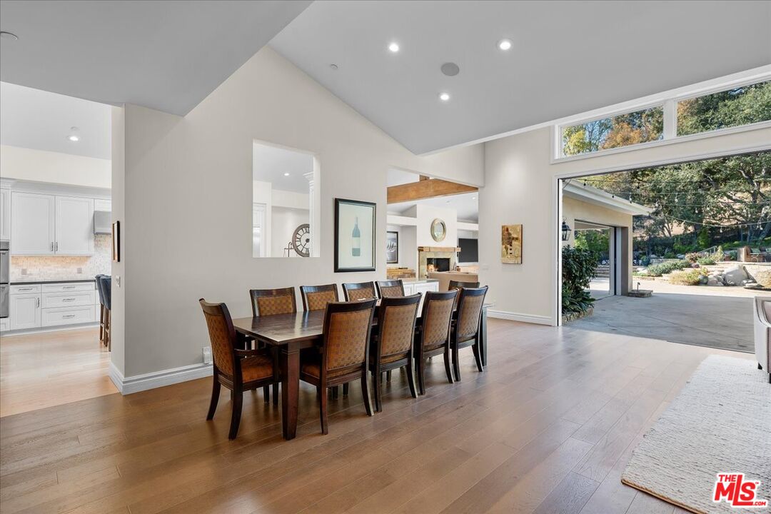 809 Leonard Road Los Angeles, CA 90049 - Photo 12 of 72 a view of a dining area with furniture and wooden floor