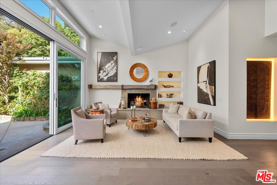 809 Leonard Road Los Angeles, CA 90049 - Photo 15 of 72 a living room with fireplace furniture and a large window