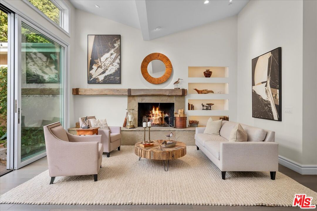809 Leonard Road Los Angeles, CA 90049 - Photo 18 of 72 a living room with furniture a rug and a fireplace
