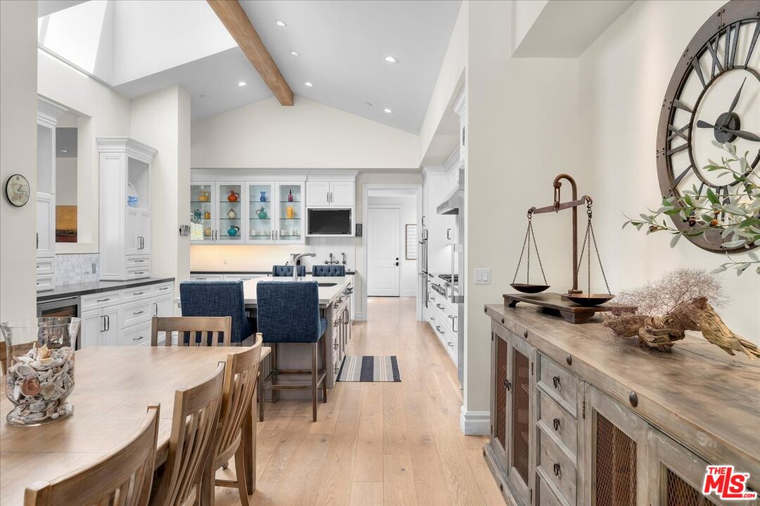 809 Leonard Road Los Angeles, CA 90049 - Photo 25 of 72 a kitchen with stainless steel appliances kitchen island granite countertop a stove a sink and a refrigerator