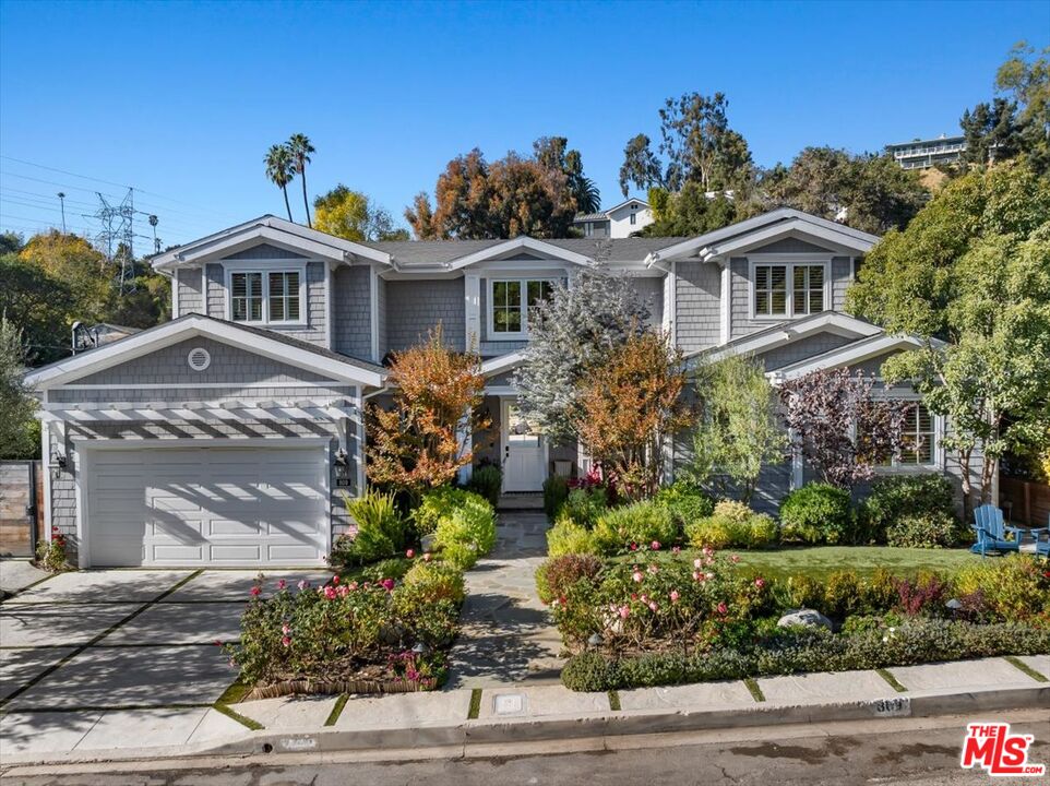 809 Leonard Road Los Angeles, CA 90049 - Photo 3 of 72 a front view of a house with a yard