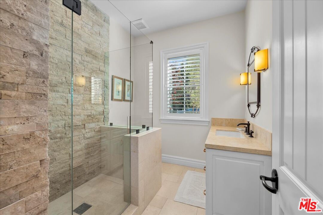 809 Leonard Road Los Angeles, CA 90049 - Photo 44 of 72 a bathroom with a sink and a mirror