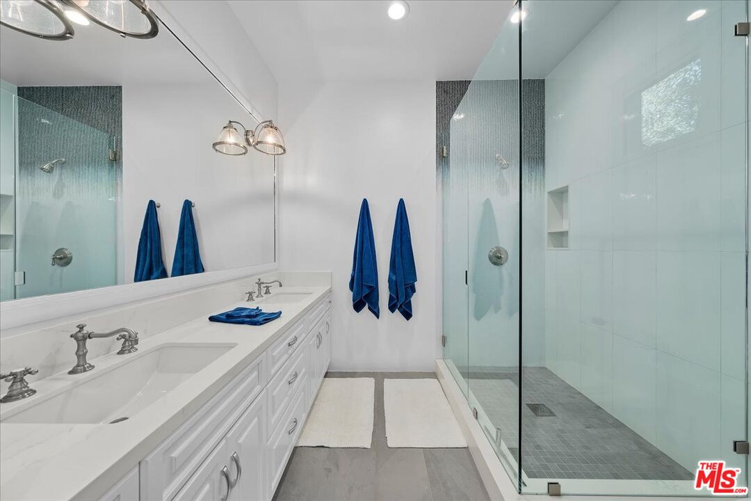 809 Leonard Road Los Angeles, CA 90049 - Photo 48 of 72 a bathroom with a sink and mirror