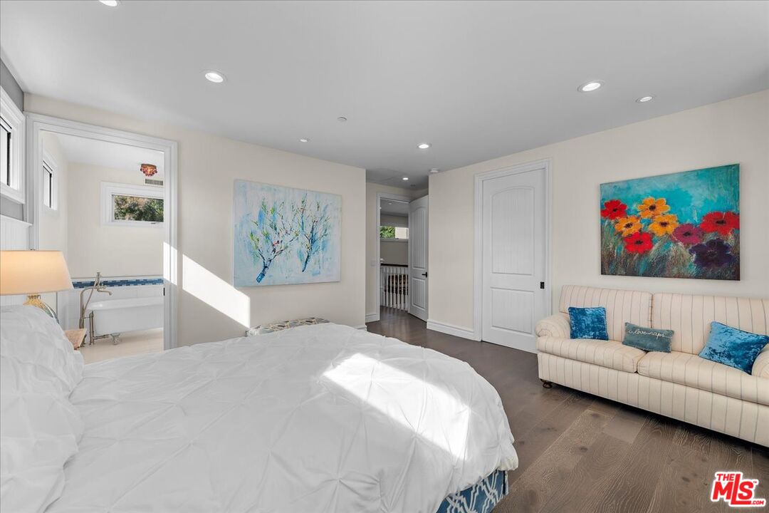 809 Leonard Road Los Angeles, CA 90049 - Photo 51 of 72 a spacious bedroom with a large bed a couch and painting on the wall