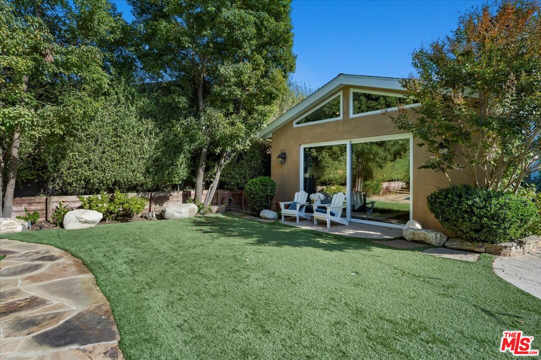 809 Leonard Road Los Angeles, CA 90049 - Photo 59 of 72 a front view of a house with backyard and sitting area