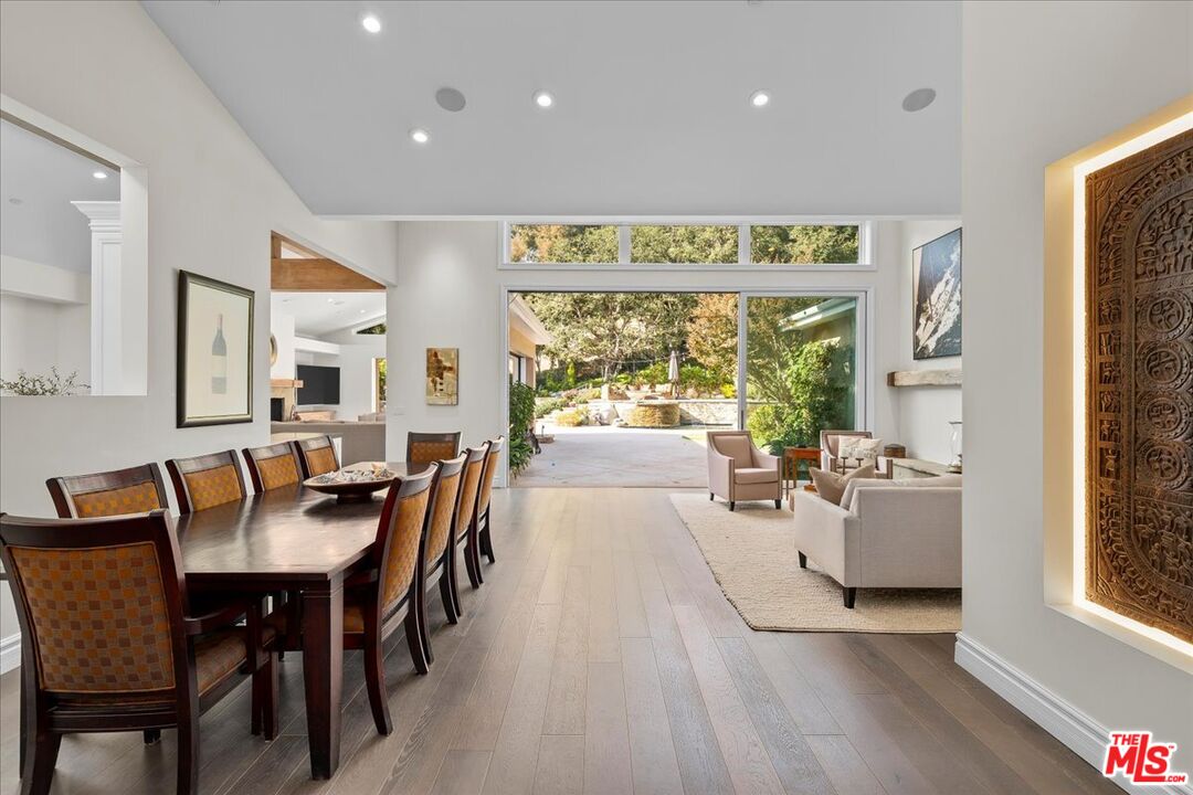 809 Leonard Road Los Angeles, CA 90049 - Photo 10 of 72 a view of a dining room with furniture a chandelier and wooden floor