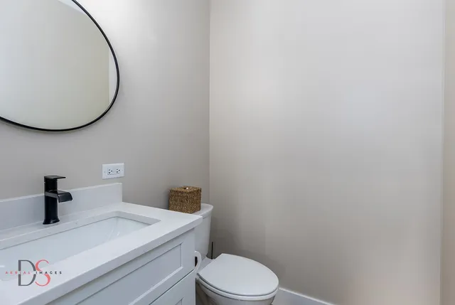 a bathroom with a toilet and a mirror
