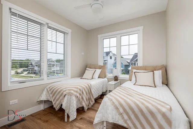 a bedroom with two beds and a large window