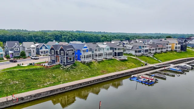 an aerial view of a house with a garden and lake view