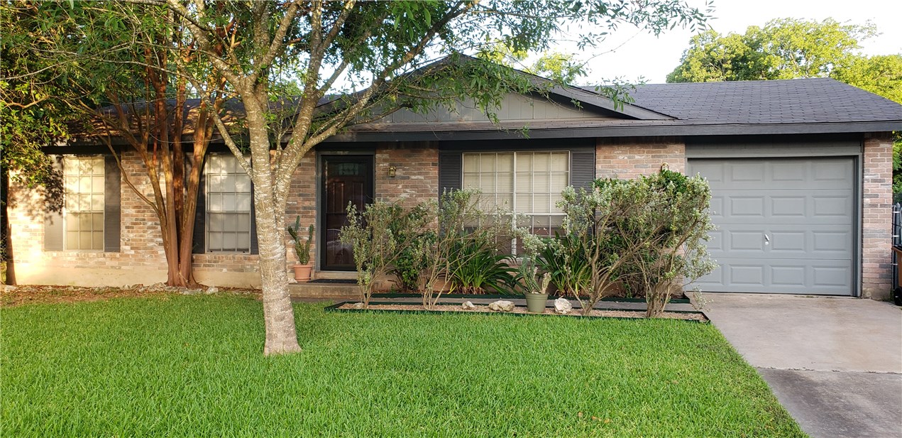 7004 Castlekeep Way Austin, TX 78745 - Photo 1 of 1 a front view of a house with a garden