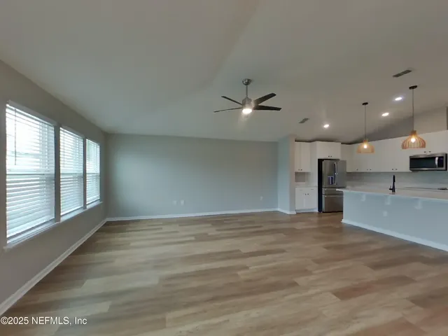 a view of an empty room with a window