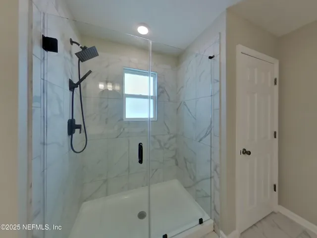 a bathroom with a glass shower door