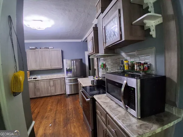 a kitchen with stainless steel appliances granite countertop a stove and a refrigerator