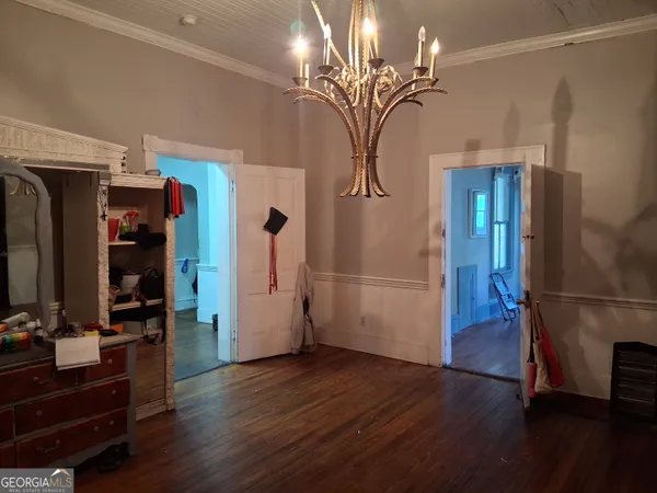 a view of a livingroom with wooden floor and furniture