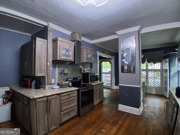 a kitchen with a sink cabinets and wooden floor