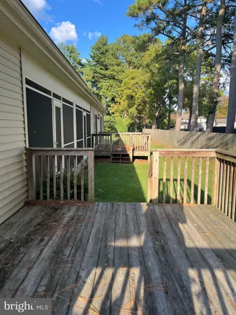 a view of backyard with deck and garden