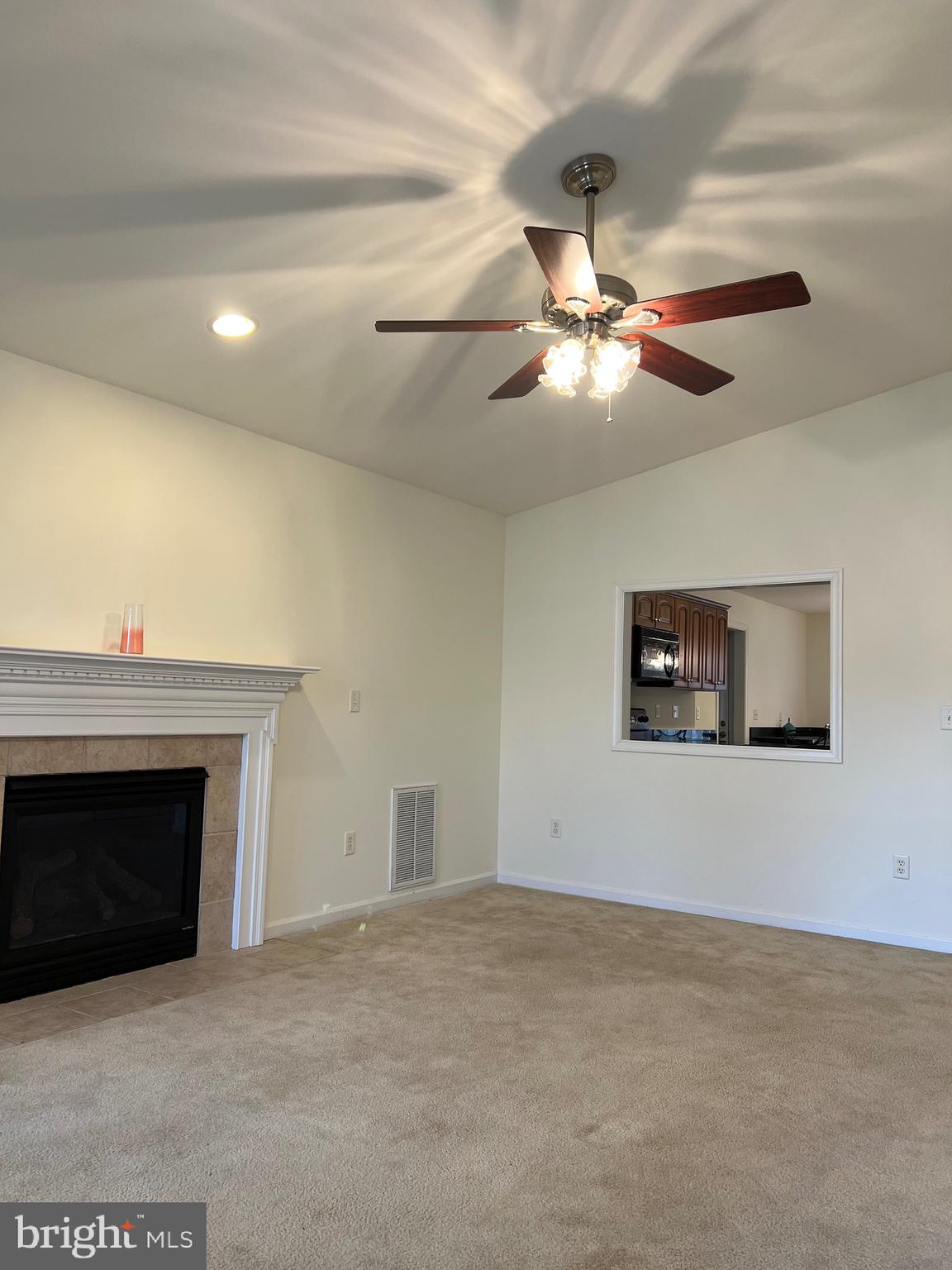 30471 Manor Drive Princess Anne, MD 21853 - Photo 7 of 23 a living room with a fireplace and a ceiling fan
