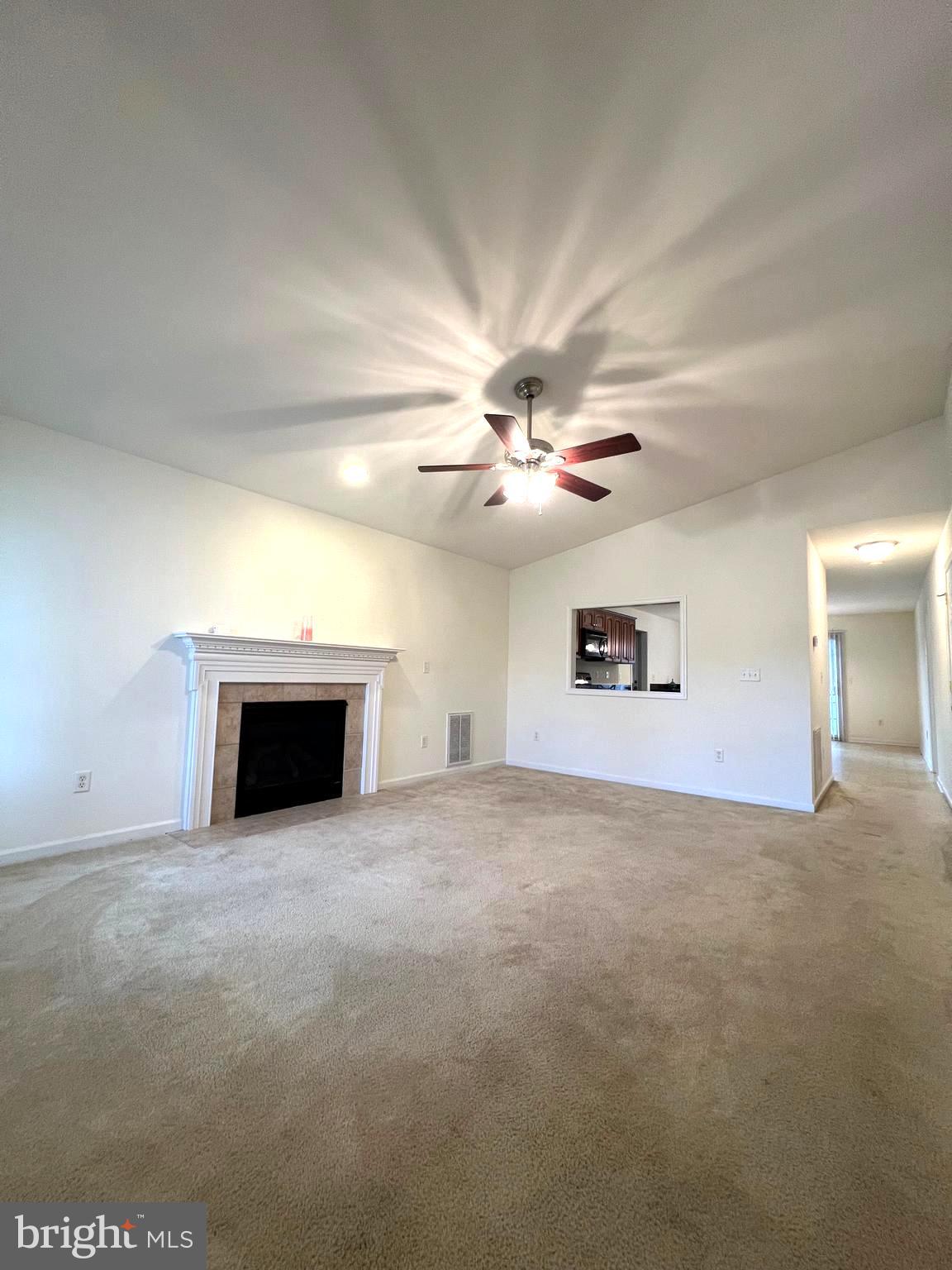30471 Manor Drive Princess Anne, MD 21853 - Photo 9 of 23 a view of a livingroom with a ceiling fan and a fireplace
