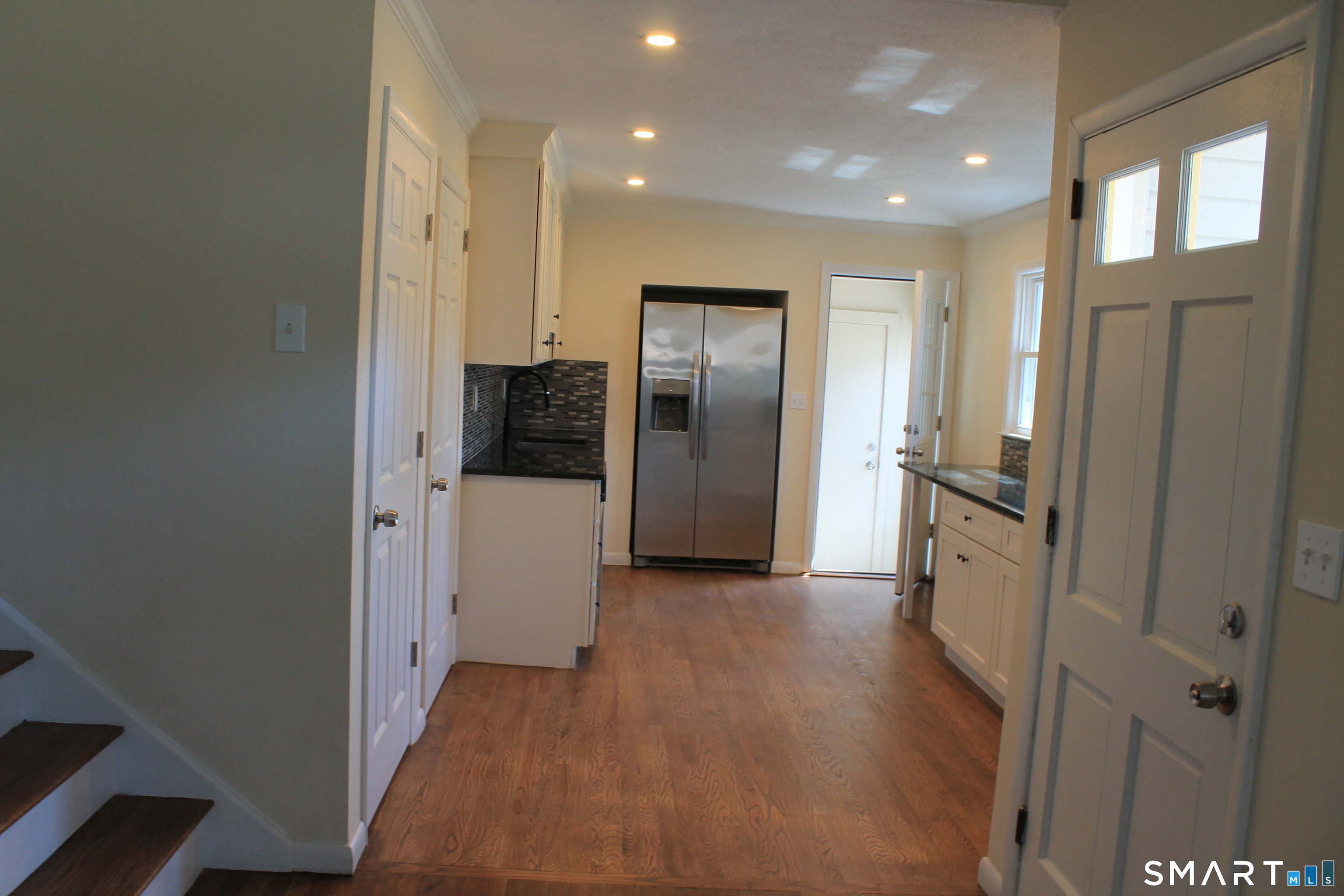 134 Sunset Street Windsor Locks, CT 06096 - Photo 9 of 23 a view of hallway with kitchen and refrigerator