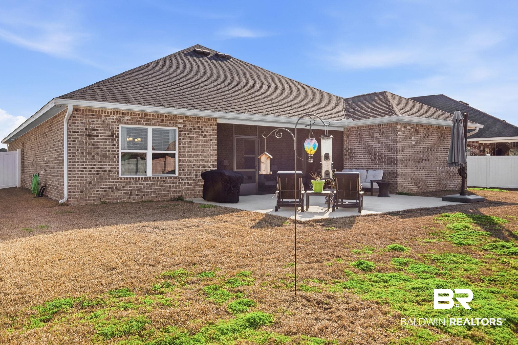 11123 Genuine Risk Circle Daphne, AL 36526 - Photo 50 of 67 Rear view of property featuring roof with shingles, brick siding, and a patio