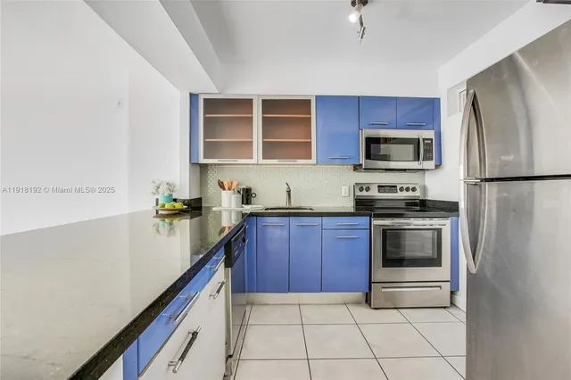 a kitchen with stainless steel appliances a stove microwave and refrigerator