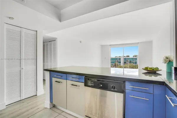 a kitchen with granite countertop a sink and a wooden cabinets