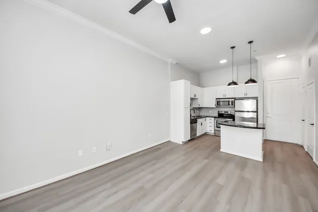 a kitchen with a refrigerator and white cabinets