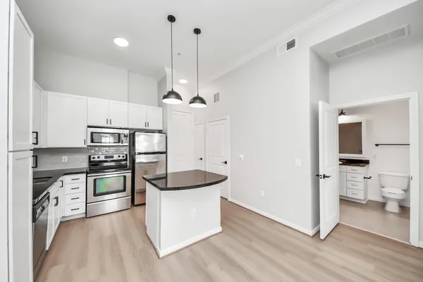 a kitchen with stainless steel appliances a stove a sink and a refrigerator