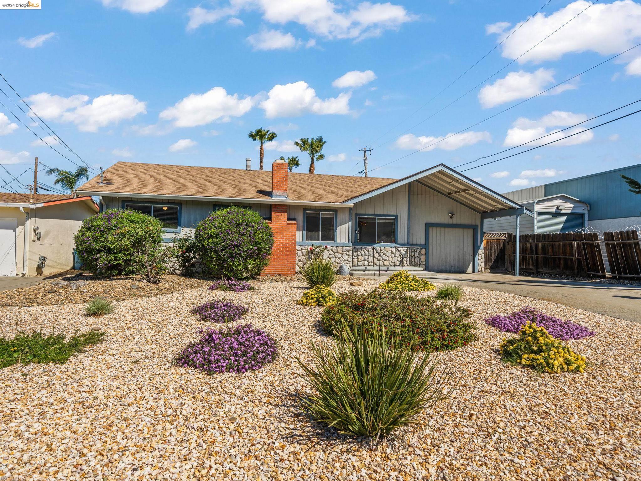 215 Sunset Drive Antioch, CA 94509 - Photo 1 of 1 a front view of a house with garden