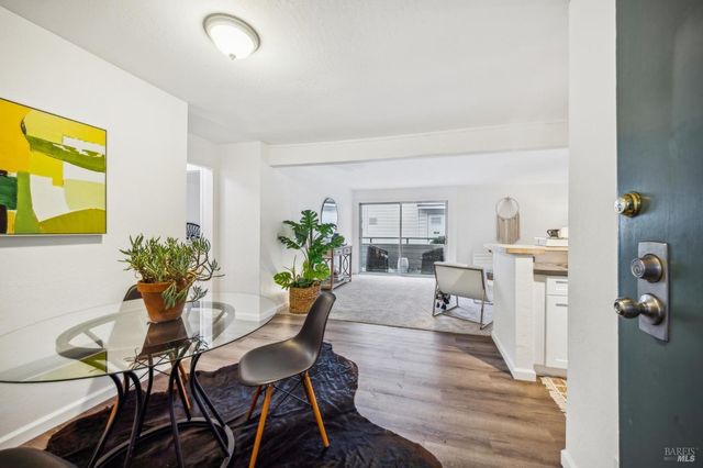 a view of a dining room with furniture and a potted plant