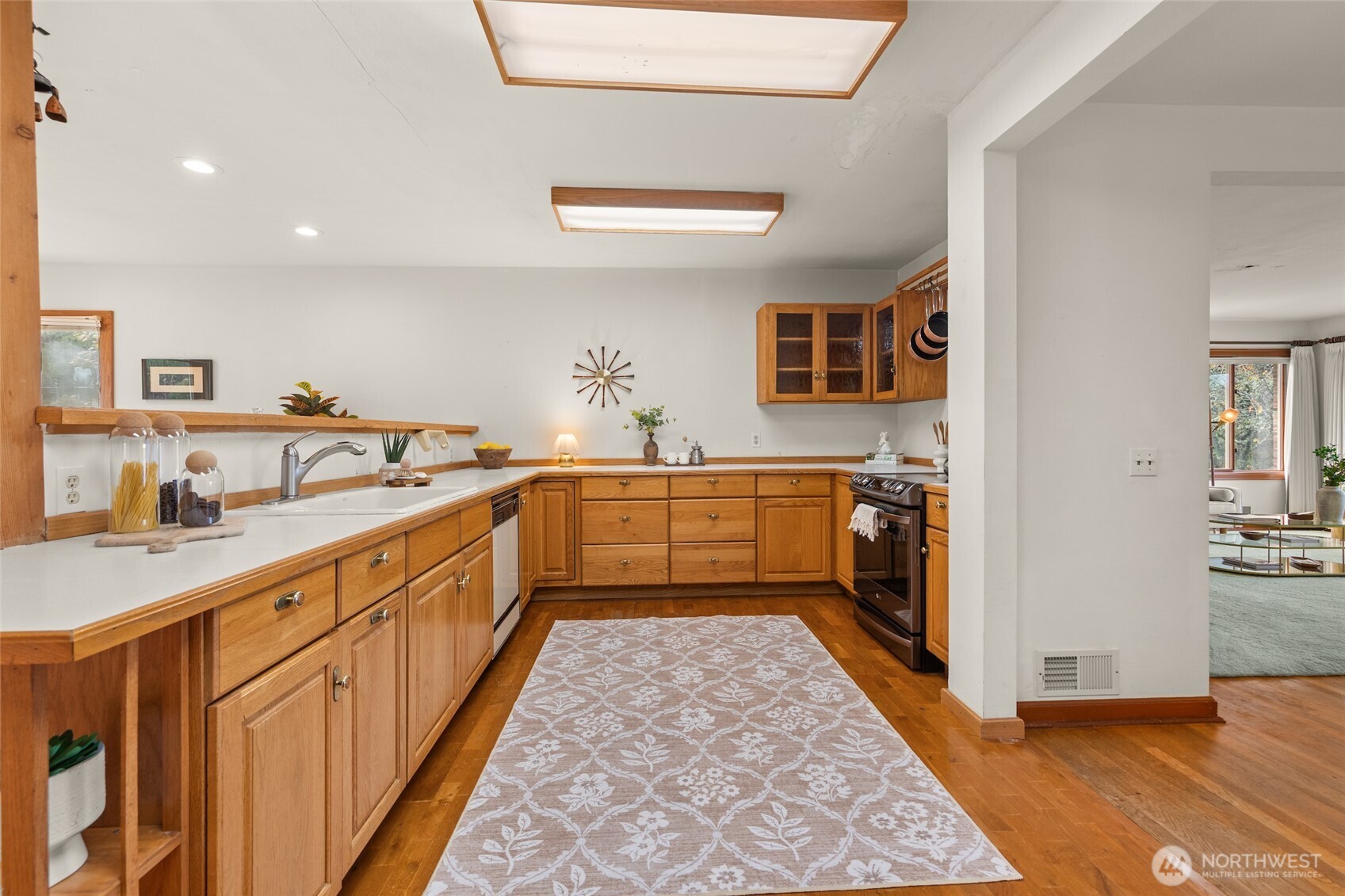 9619 Southwest 268th Street Vashon, WA 98070 - Photo 18 of 37 a large kitchen with stainless steel appliances granite countertop a sink and cabinets