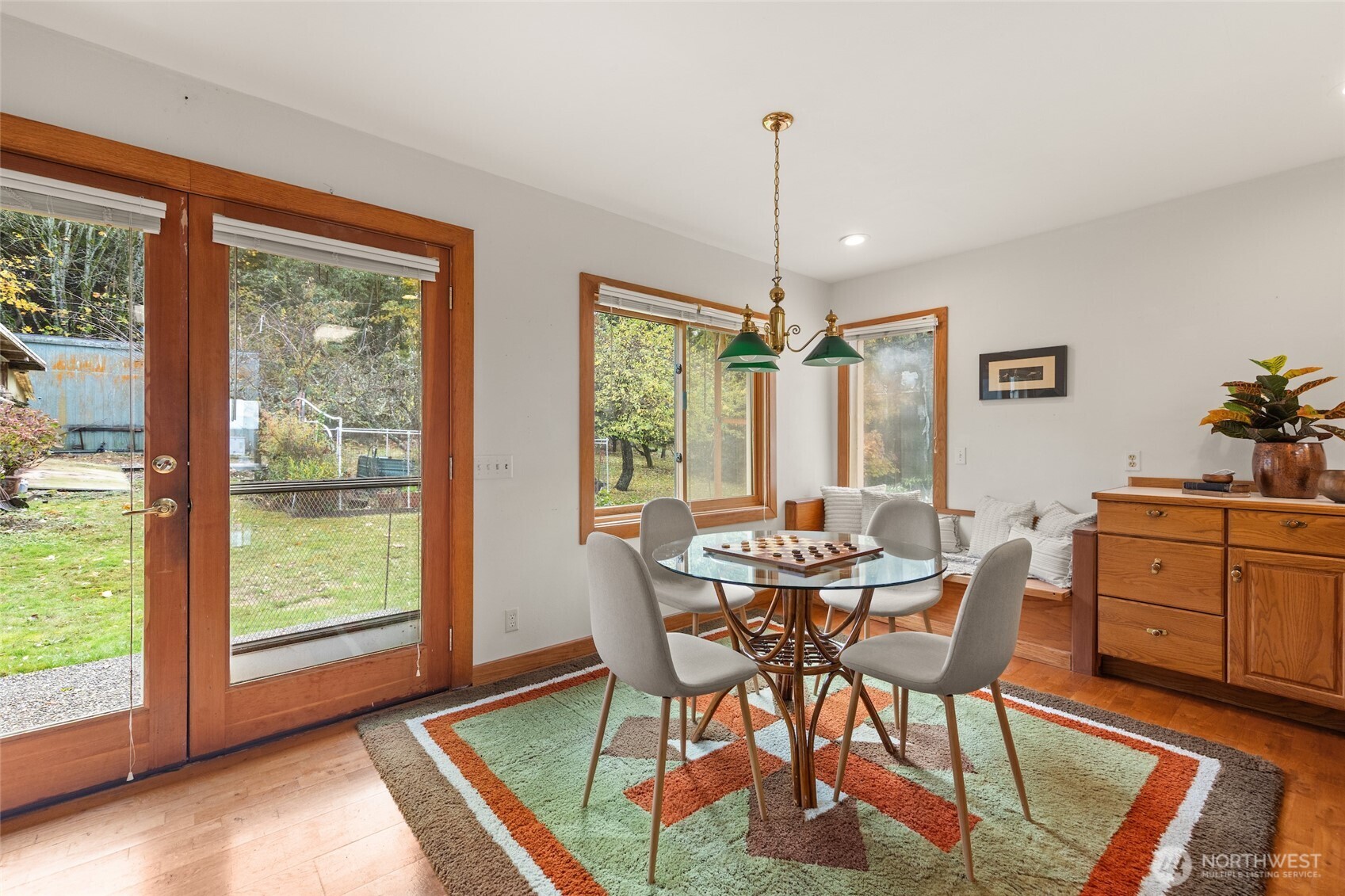 9619 Southwest 268th Street Vashon, WA 98070 - Photo 21 of 37 a view of a dining room with furniture window and wooden floor