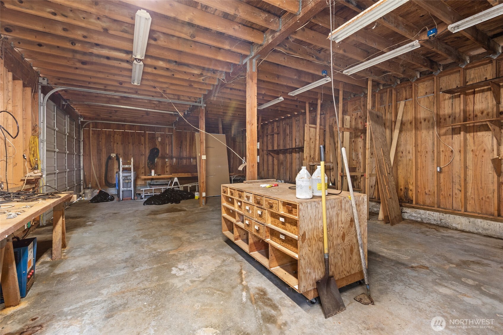 9619 Southwest 268th Street Vashon, WA 98070 - Photo 30 of 37 a bed room with a bed and a chandelier