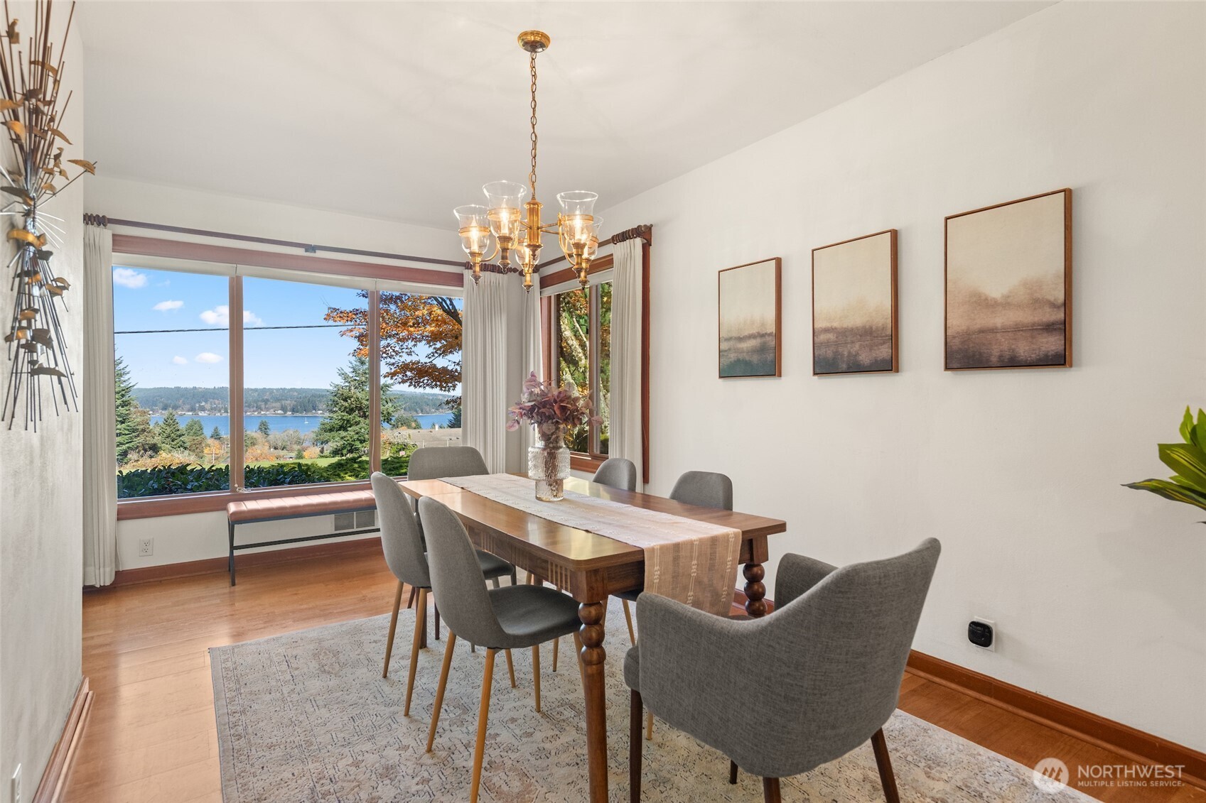 9619 Southwest 268th Street Vashon, WA 98070 - Photo 9 of 37 a dining room with furniture a chandelier and wooden floor