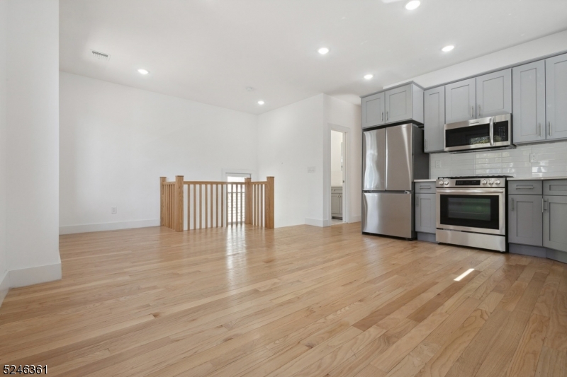 492 South 20th Street, Unit 2 Newark, NJ 07103 - Photo 2 of 12 a view of kitchen with stainless steel appliances a refrigerator and a stove top oven