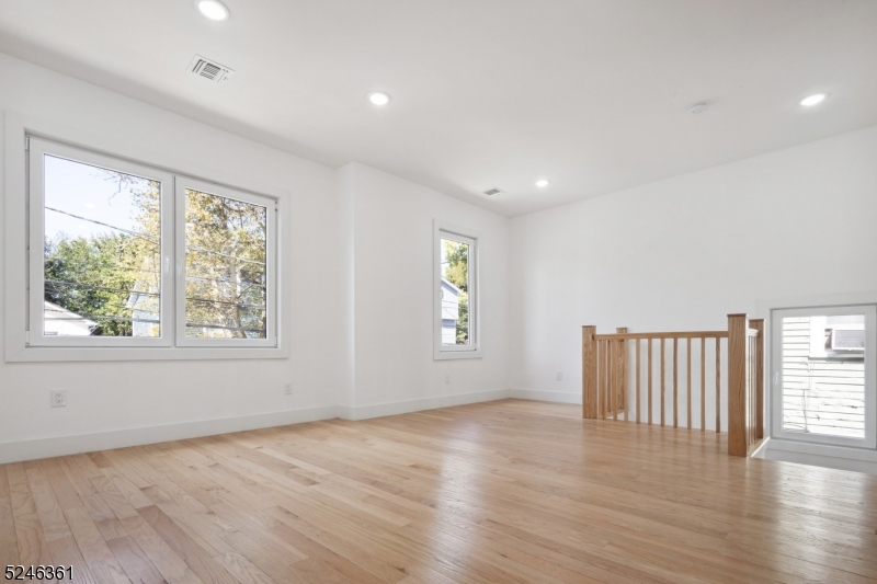 492 South 20th Street, Unit 2 Newark, NJ 07103 - Photo 3 of 12 an empty room with wooden floor and windows