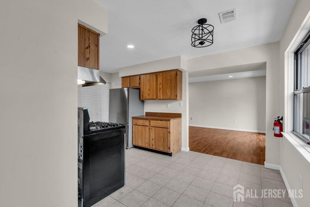 1610 Raspberry Court Edison, NJ 08817 - Photo 10 of 18 a kitchen with a stove and a refrigerator