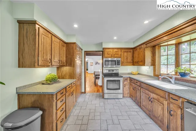 a spacious bedroom with a bed and a flat screen tv